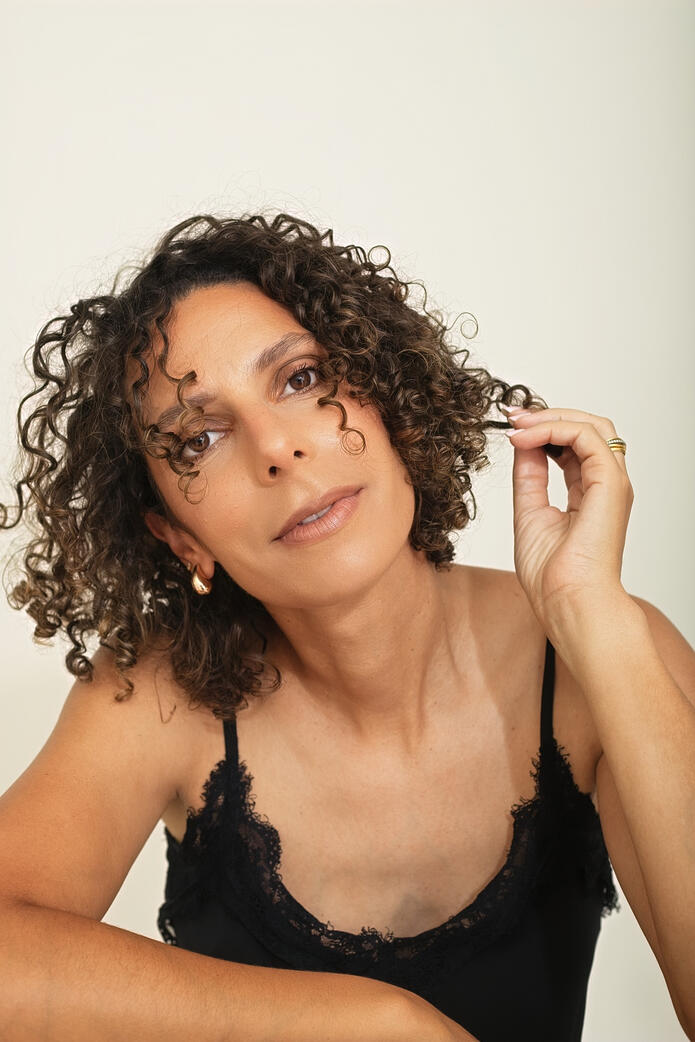 Photo of curly woman in black top, Berlin studio Photo of curly woman in black top, Berlin studio photoshoot